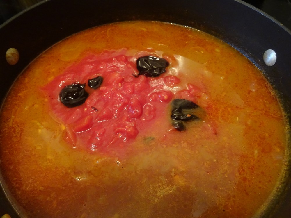 adding tomatos and tamarind